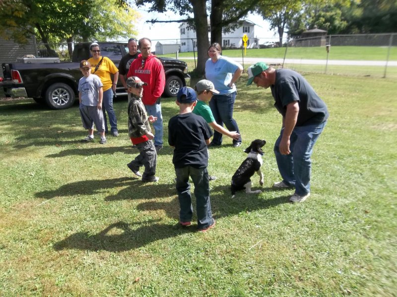 Camille at a youth event after retrieving to hand the bystander is afraid to get a little wet.